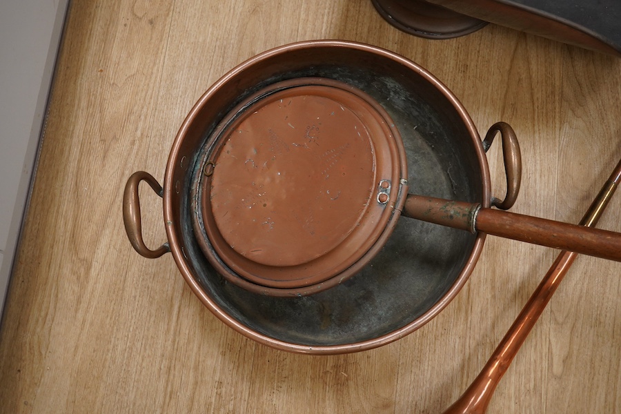 Victorian copper, including a two handled preserve pan, a copper hunting horn, a helmet coal scuttle and a warming pan. Scuttle 32cm high. Condition - hunting horn dented